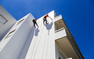 Industrial Alpinist Work On White Wall