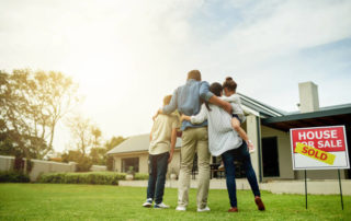 Shot Of A Family Of Four Viewing Their New Home Together