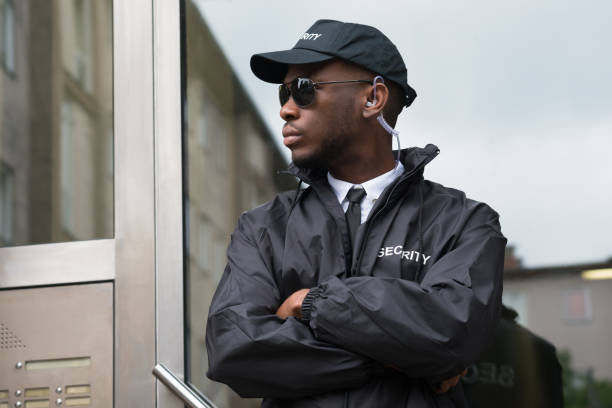 Portrait Of Young African Male Security Guard Standing Arms Crossed