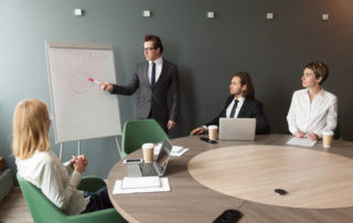 Confident Speaker Business Coach Gives Presentation To Team With