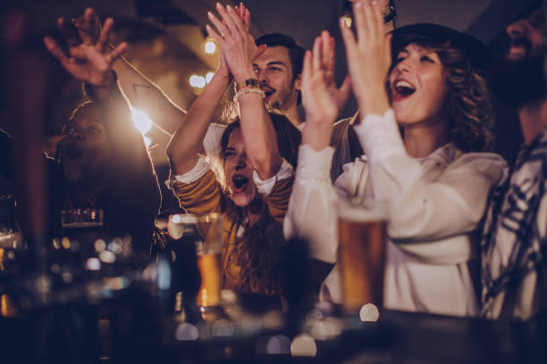 Group Of Friends Cheering With Beer In A Pub