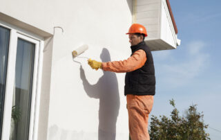 Worker Is Painting A Wall