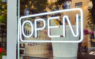 Neon Open Sign Illuminated In A Window Of A Store