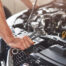 Picture Showing Muscular Car Service Worker Repairing Vehicle